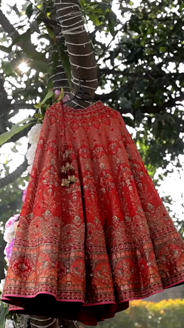 Vertical Shot of Bridal Lehenga Hanging at Wedding Ceremony