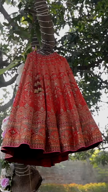 Vertical Shot of Bridal Lehenga Hanging at Wedding Ceremony
