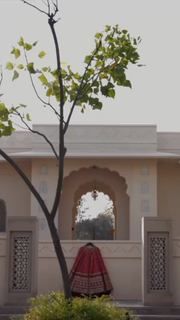 Vertical Shot of Bridal Lehenga Hanging at Wedding Ceremony