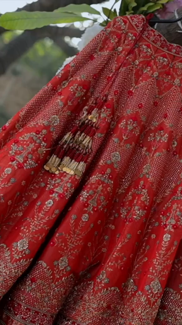 Vertical Shot of Bridal Lehenga Hanging at Wedding Ceremony
