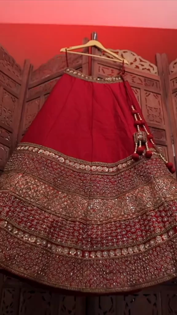 Vertical Shot of Bridal Lehenga Hanging at Wedding Ceremony