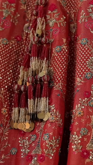 Vertical Shot of Bridal Lehenga Hanging at Wedding Ceremony