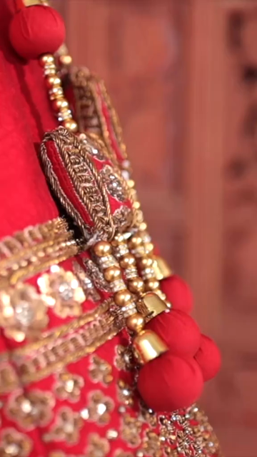 Vertical Shot of Bridal Lehenga Hanging at Wedding Ceremony
