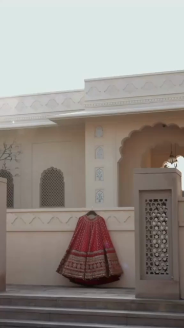 Vertical Shot of Bridal Lehenga Hanging at Wedding Ceremony