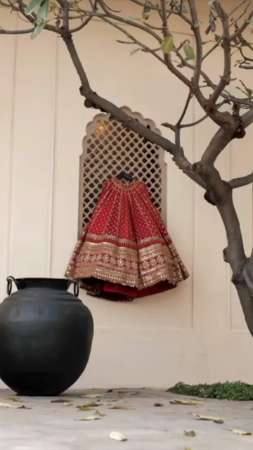 Vertical Shot of Bridal Lehenga Hanging at Wedding Ceremony