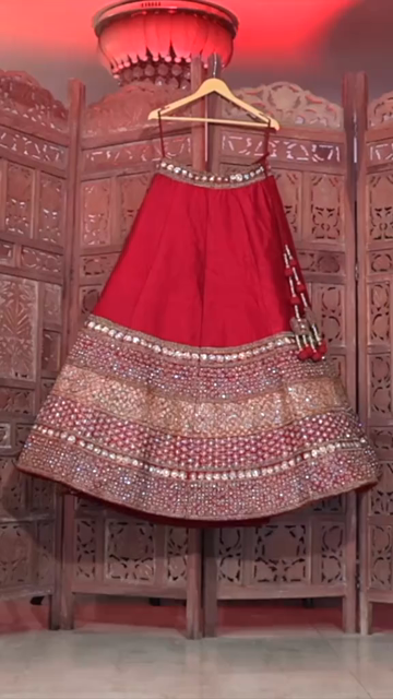 Vertical Shot of Bridal Lehenga Hanging at Wedding Ceremony