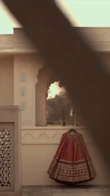 Vertical Shot of Bridal Lehenga Hanging at Wedding Ceremony