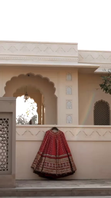 Vertical Shot of Bridal Lehenga Hanging at Wedding Ceremony