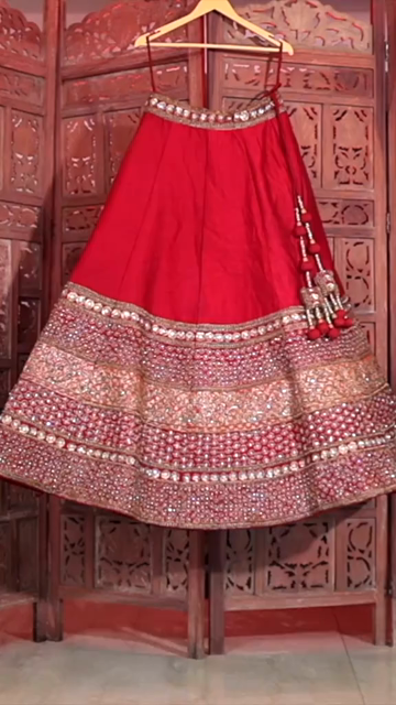 Vertical Shot of Bridal Lehenga Hanging at Wedding Ceremony
