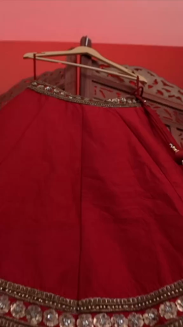 Vertical Shot of Bridal Lehenga Hanging at Wedding Ceremony