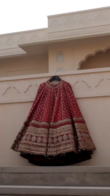 Vertical Shot of Bridal Lehenga Hanging at Wedding Ceremony