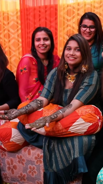 Vertical Shot of Bride Celebrating Mehendi Ceremony with Her Cousins