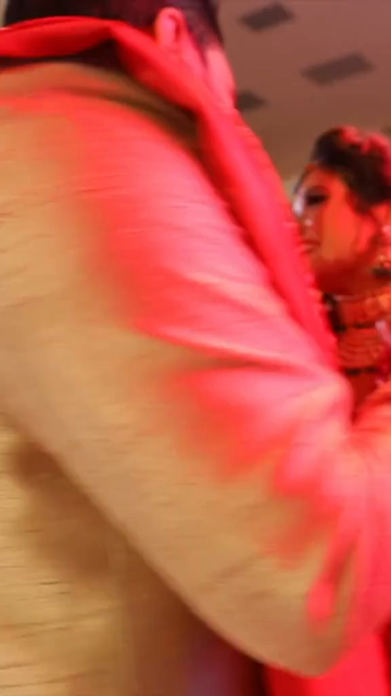 Vertical Shot of Bride and Groom Dancing Together at Their Indian Wedding