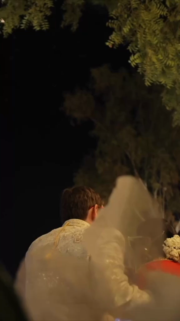 Vertical Shot of Couple Posing During Their Wedding Reception
