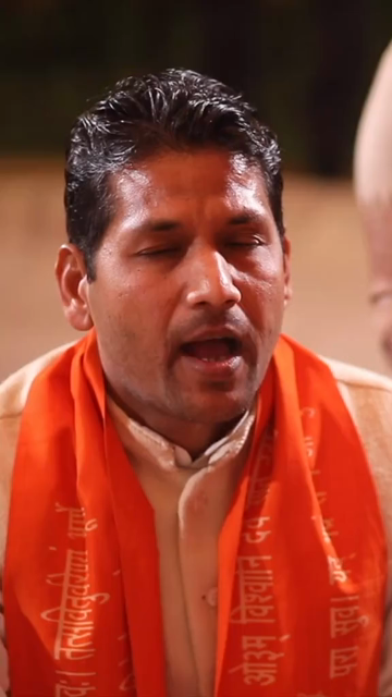 Vertical Shot of Hindu Priest Performing Wedding Rituals at an Indian Wedding