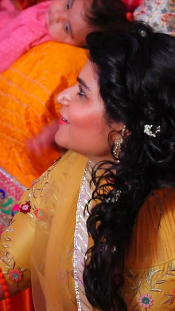Vertical Shot of Woman Clapping at Indian Wedding Celebration