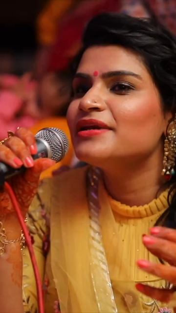 Vertical Shot of Woman Hosting Haldi Ceremony at an Indian Wedding