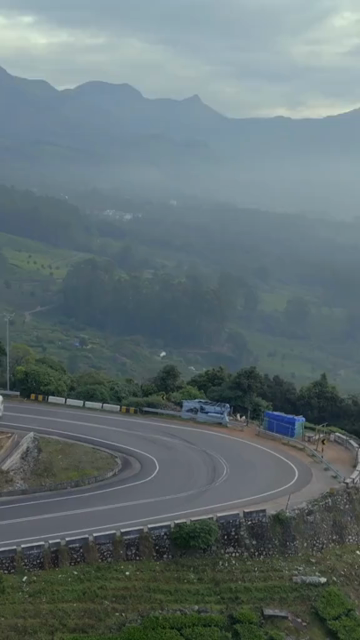 Vertical aerial view of winding roads through lush tea plantations in Munnar Kerala India